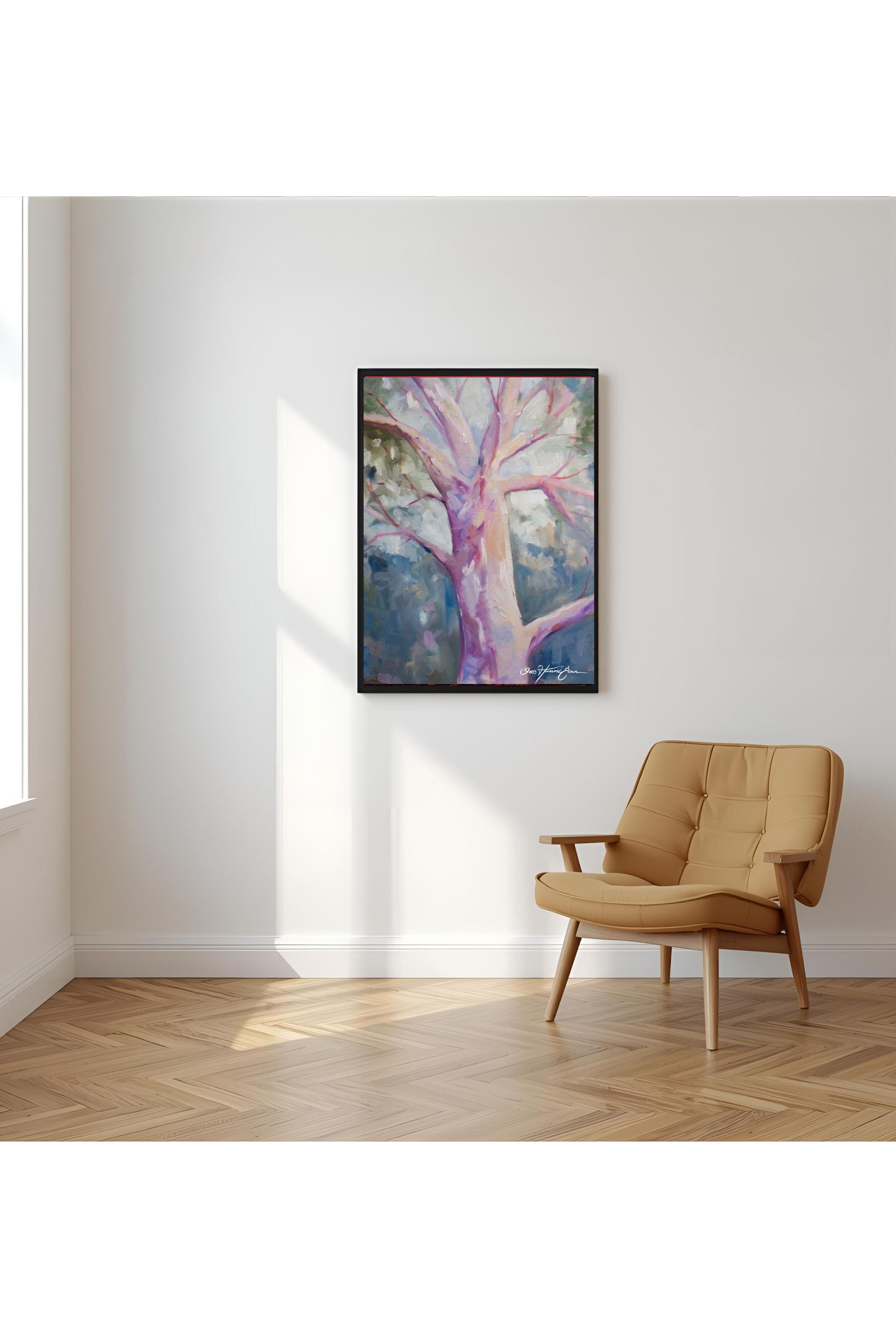 Tan armchair in a room with a large abstract painting on the wall.
