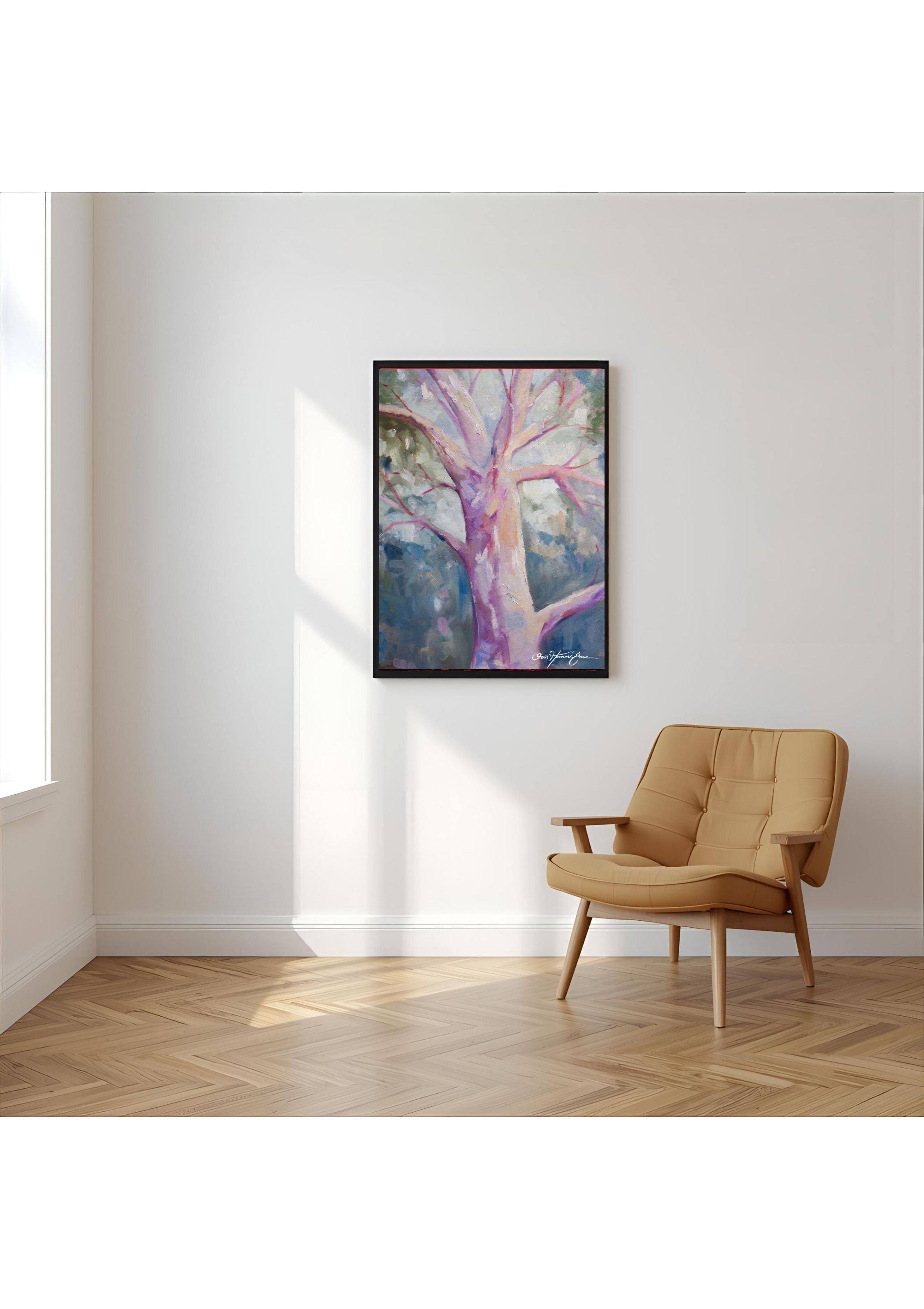 Tan armchair in a room with a large abstract painting on the wall.